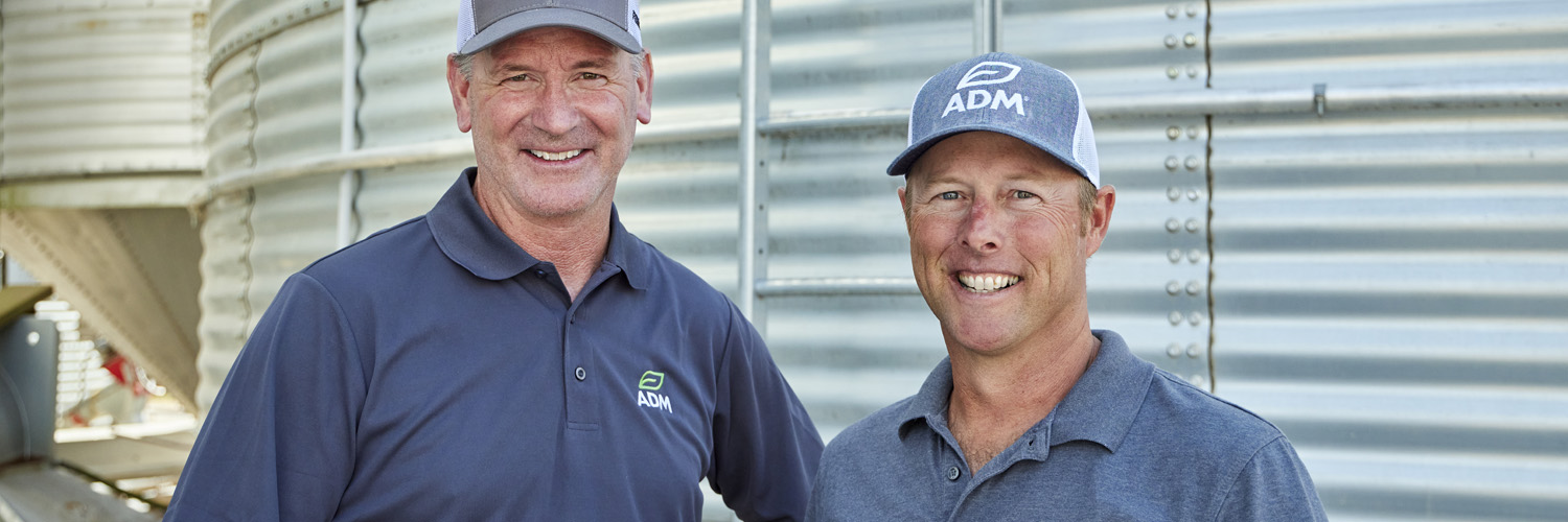 two men smiling at the camera