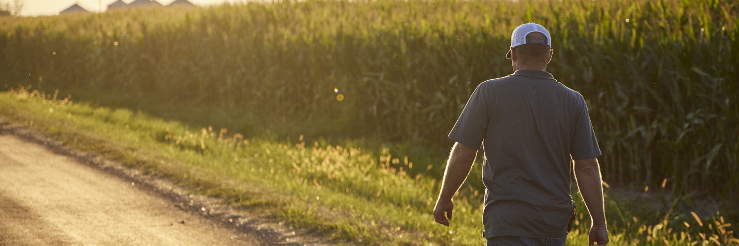 farmer walking down a road